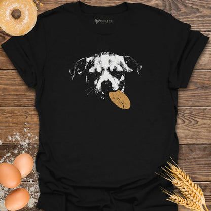 Black t-shirt featuring a white graphic of a dog holding a brown cookie in its mouth.